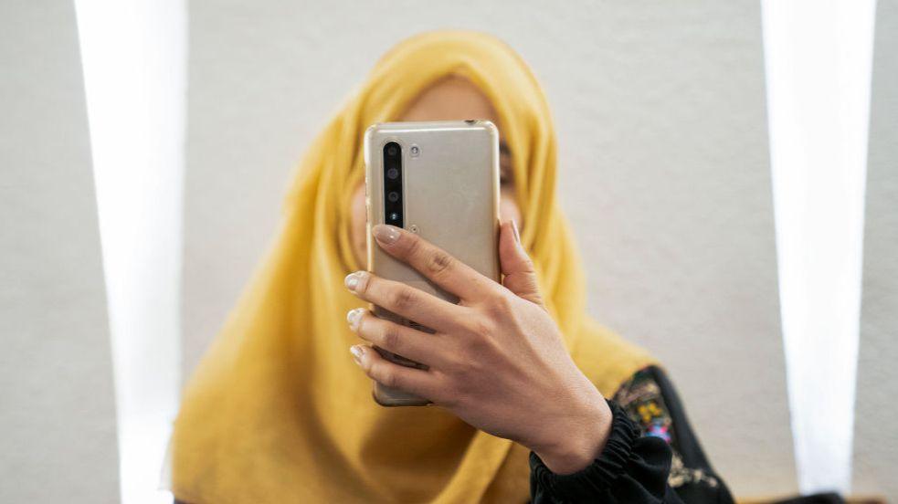 File photo of a woman holding a phone