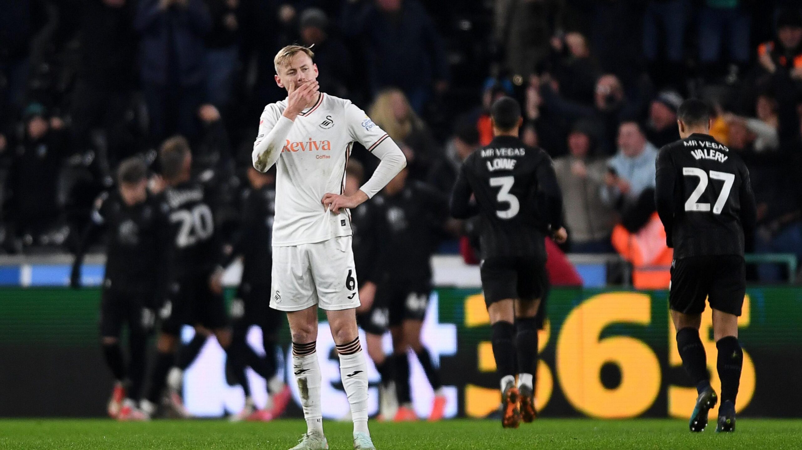Harry Darling looks disappointed as Sheffield Wednesday players celebrate