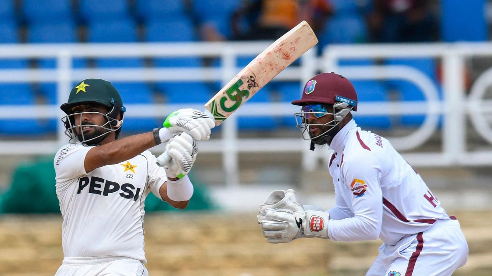 Babar Azam batting for Pakistan with West Indies wicketkeeper Shai Hope stood behind him