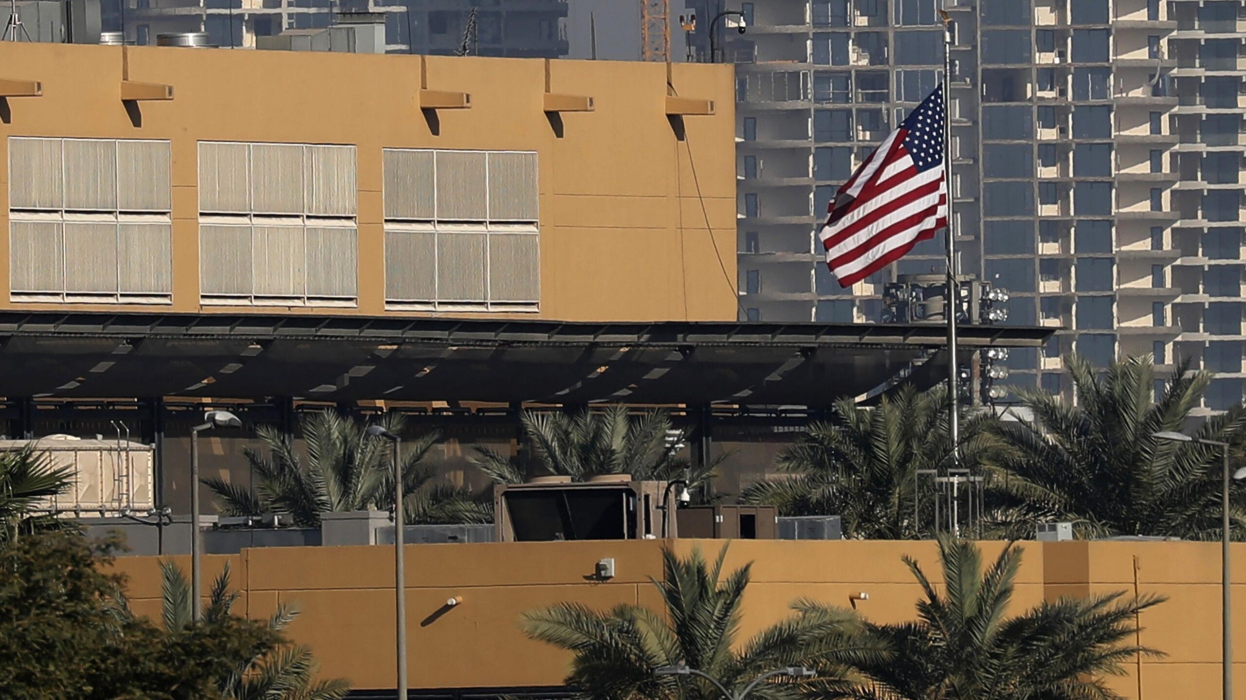 The US flag flutters outside the US Embassy, seen across the Tigris River in Baghdad's fortified Green Zone in March 2026