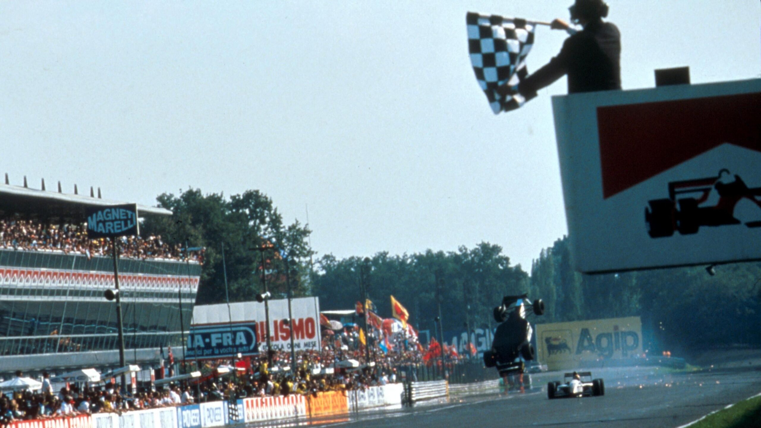The Minardi of Christian Fittiapldi is upside down and somersaulting through the air after colliding with team-mate Pierliugi Martini on the approach to the line in the 1993 Italian Grand Prix