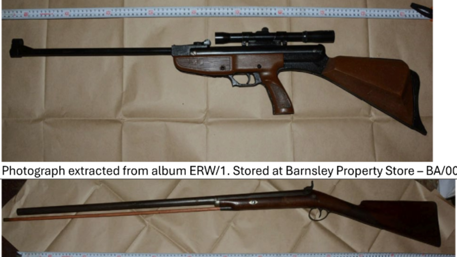 A composite of three separate photographs showing three long firearms laid horizontally on a sheet of brown paper. A white measuring scale runs parallel to each firearm, indicating that the weapons have been photographed for documentation or evidential purposes. In the top photograph, a rifle with a dark wooden stock and a black metal barrel is displayed. The firearm has a mounted telescopic sight positioned above the receiver. The barrel is relatively long and extends to the left side of the image, while the wooden butt stock is on the right. A pistol-style grip is incorporated into the stock design. The firearm is placed on a creased brown paper surface, and a measuring scale is visible along the upper edge of the photograph. In the middle photograph, a traditional long gun with a dark wooden stock and fore-end is shown. The firearm has a single long barrel extending almost the full width of the image. The stock and trigger area are located on the right side, while the muzzle points toward the left. A measuring scale runs along the bottom of the photograph. The firearm has a classic sporting-gun appearance with a simple wooden finish and metal barrel.