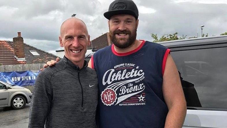 Morecambe footballer Kevin Ellison with British heavyweight boxer Tyson Fury at a petrol station in Morecambe