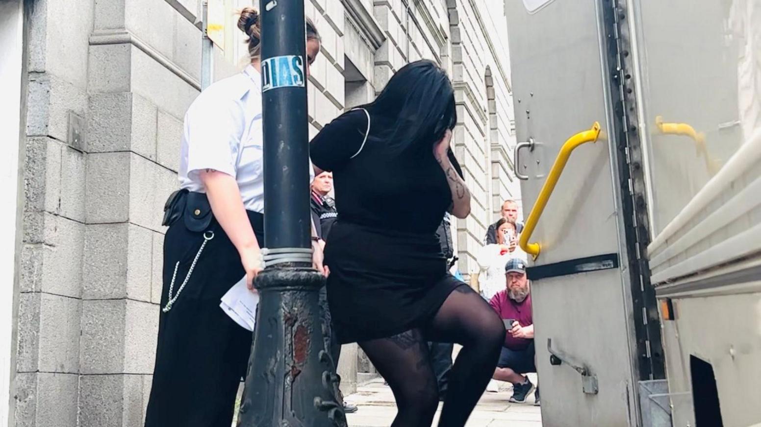Courtney Gartshore, dressed in black, is led away from the High Court in Aberdeen.