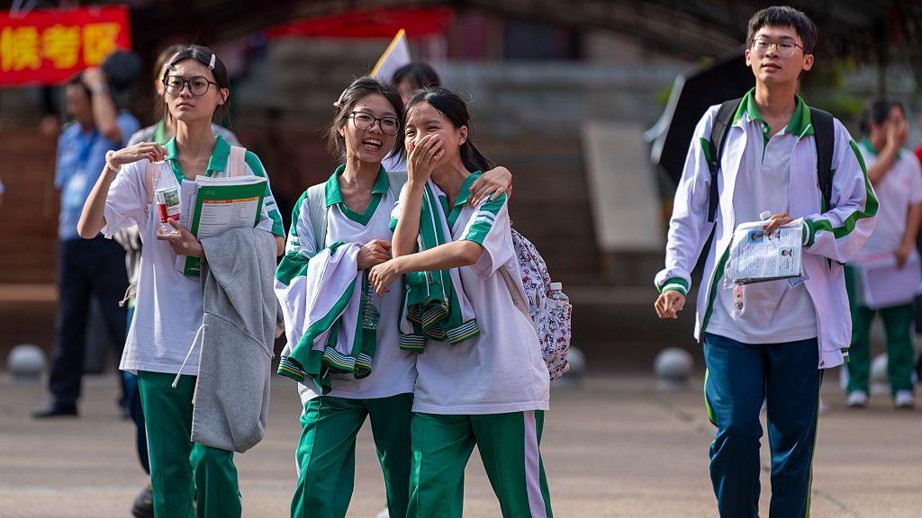 Students walk out of the examination venue for the 2026 China's National College Entrance Exam on June 7, 2026 in Qionghai, Hainan Province of China.