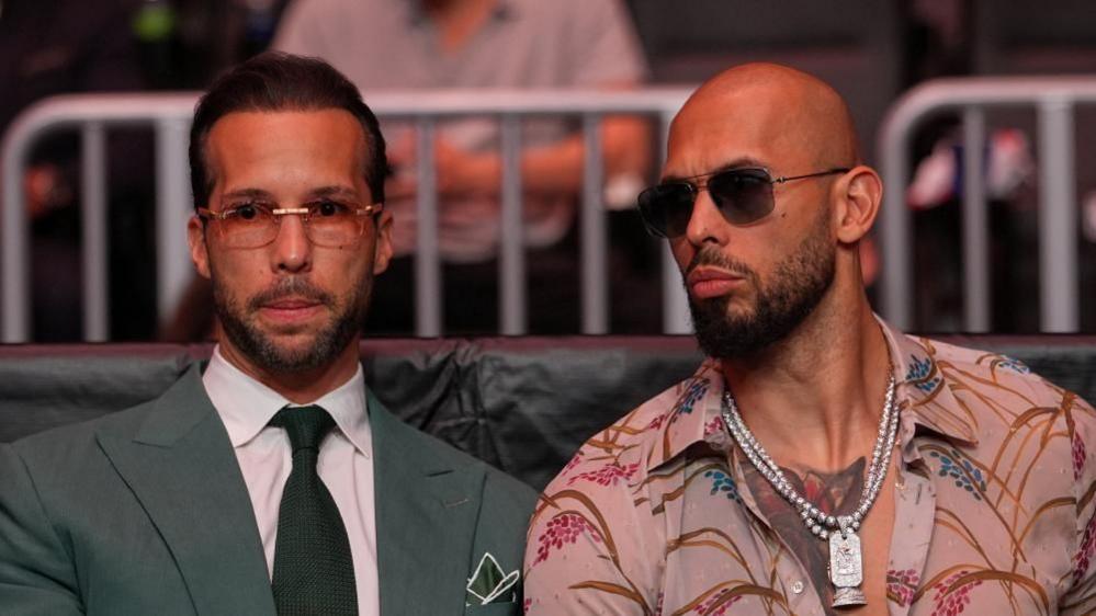 Andrew Tate and Tristan Tate are pictured sitting together at a UFC match.