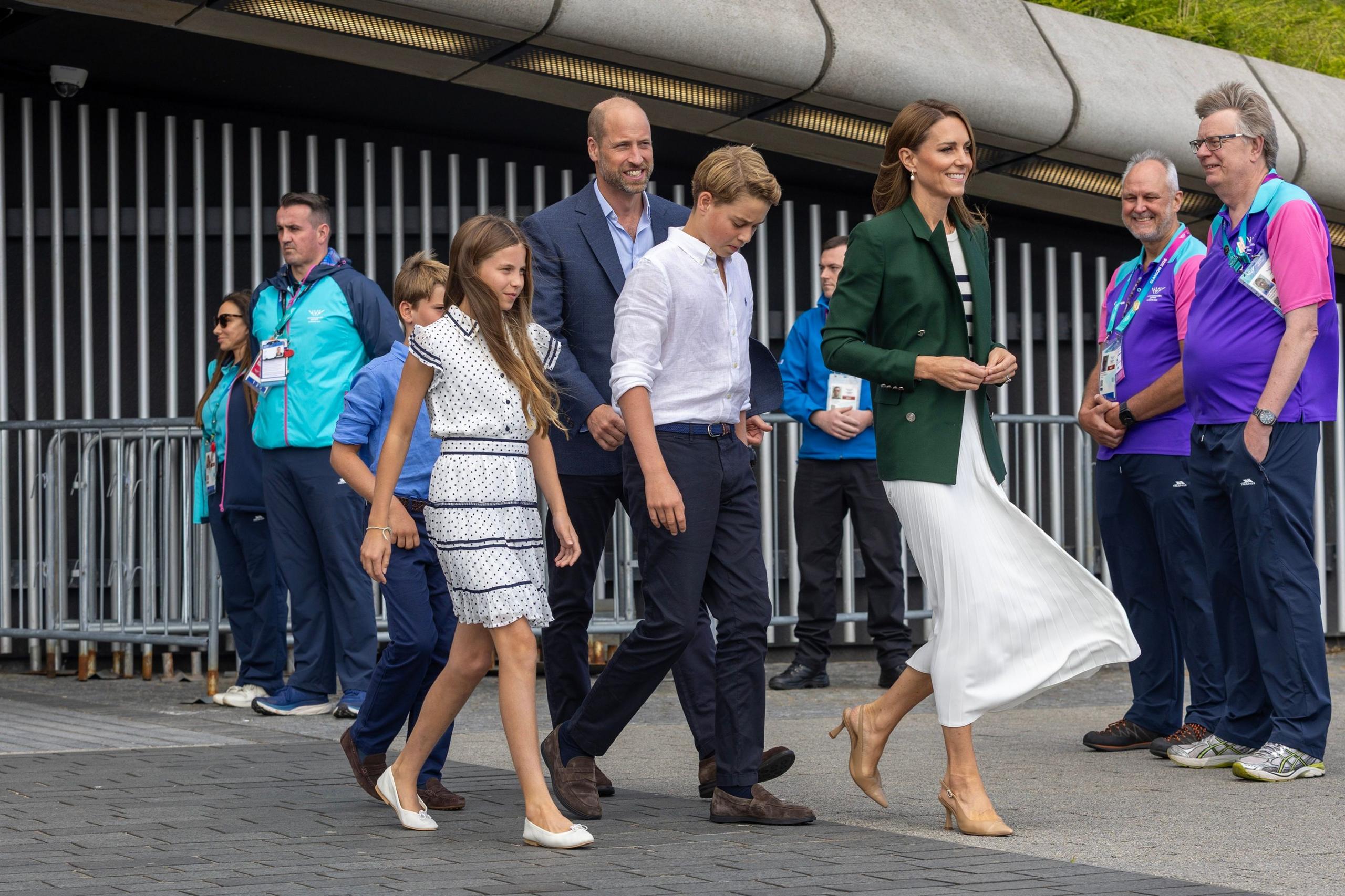 Prince William, Princess Catherine and their three children leave the Hydro in Glasgow. Commonwealth Games staff and volunteers line up to meet them