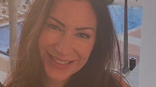 Andria Rose is seen with a swimming pool behind her