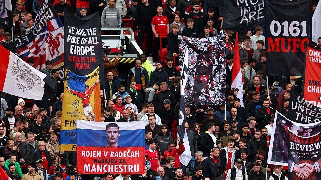 An image of a group of Manchester United fans inside Old Trafford