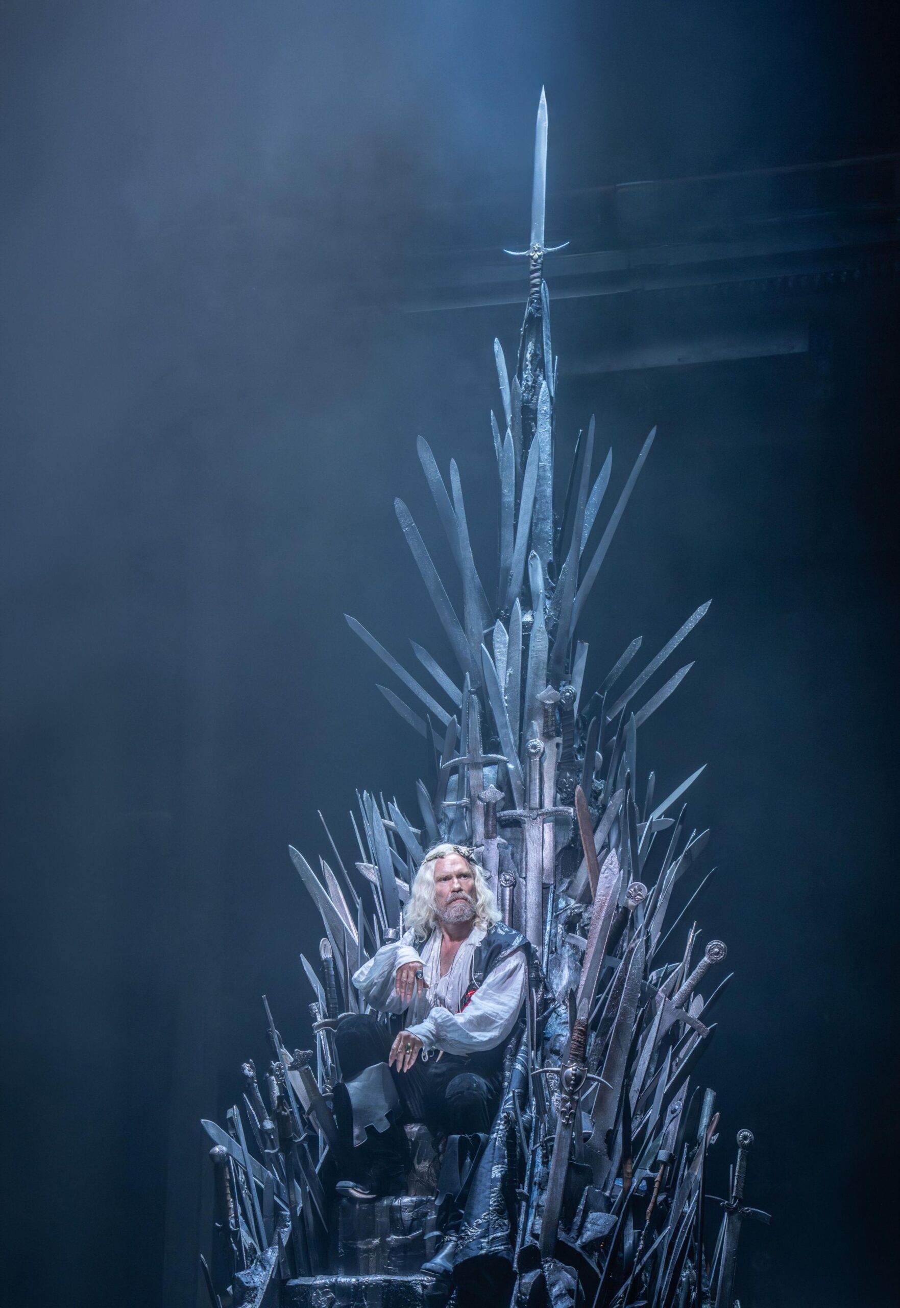 Michael Shaeffer (King Aerys II Targaryen) seated on the Iron Throne, made from dozens of protruding swords, in a scene from Game of Thrones: The Mad King.