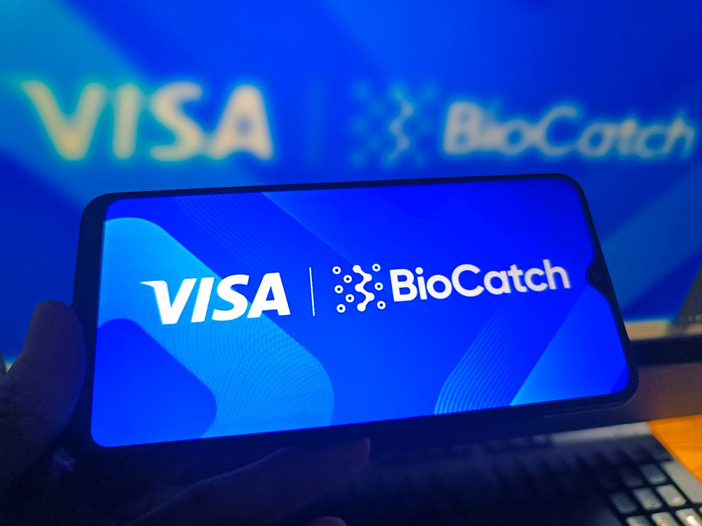 Logos of Visa and BioCatch are displayed on a smartphone