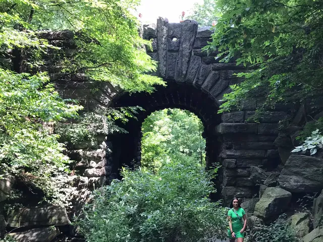 Image may contain: Arch, Architecture, Plant, Vegetation, Rock, Adult, Person, Land, Nature, Outdoors, Tree, and Woodland
