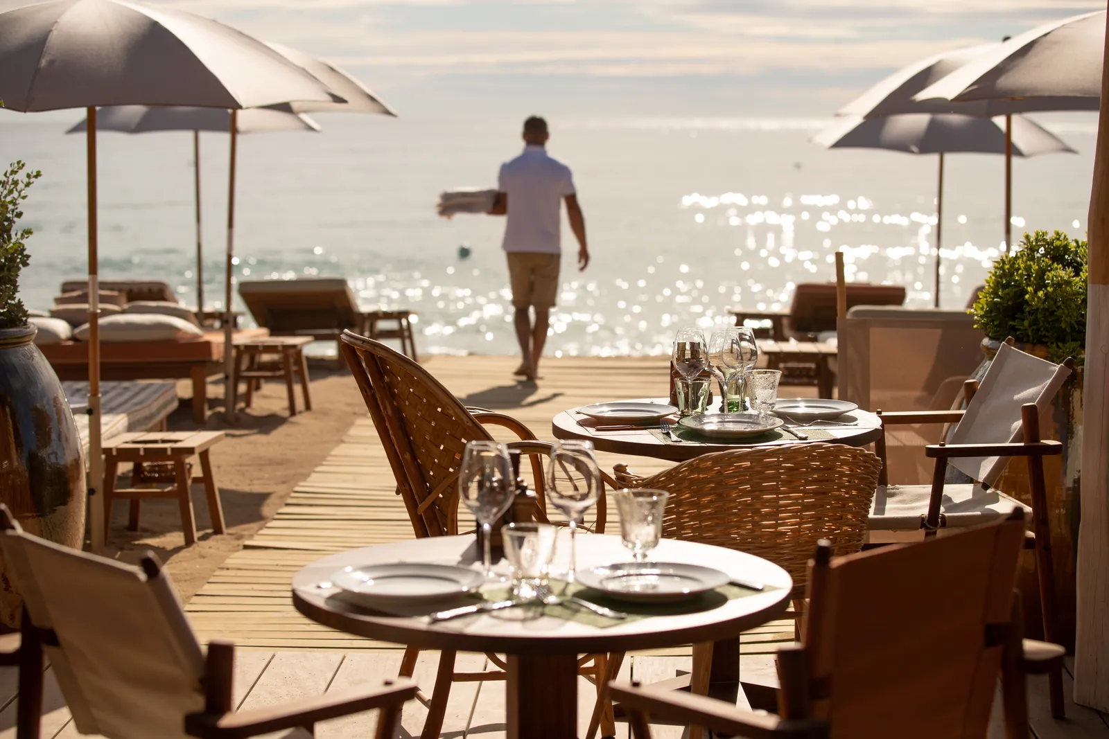 Image may contain Adult Person Nature Outdoors Furniture Table Chair Plate Cutlery Fork Countryside Cup and Farm