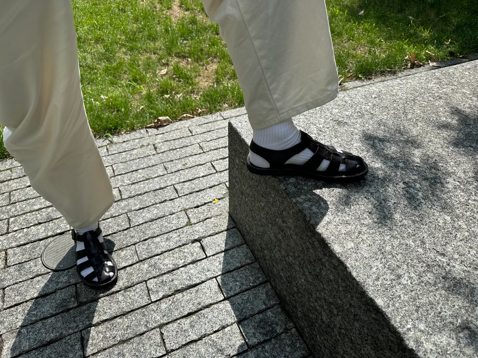 Image may contain Clothing Footwear Shoe Sneaker Path Sandal Grass Plant Floor Person Road Walkway and Rock