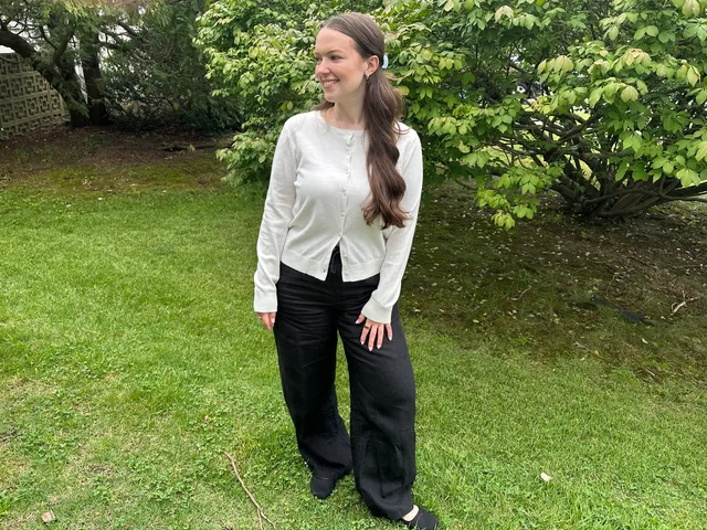 Image may contain: Clothing, Pants, Person, Standing, Sleeve, Hair, and Blouse