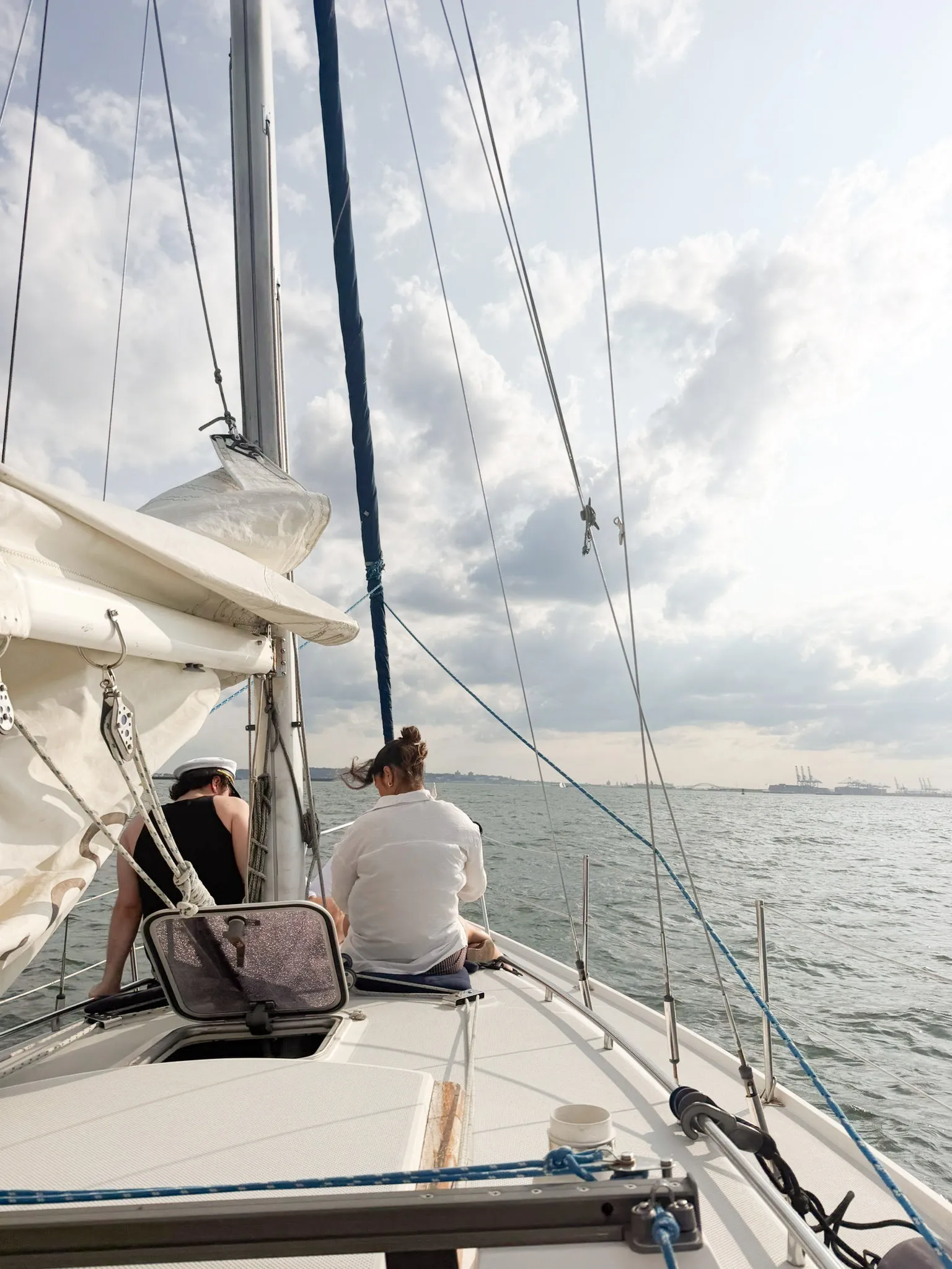 Image may contain Boat Sailboat Transportation Vehicle Yacht Adult Person Nature Outdoors Sky Clothing and Hat