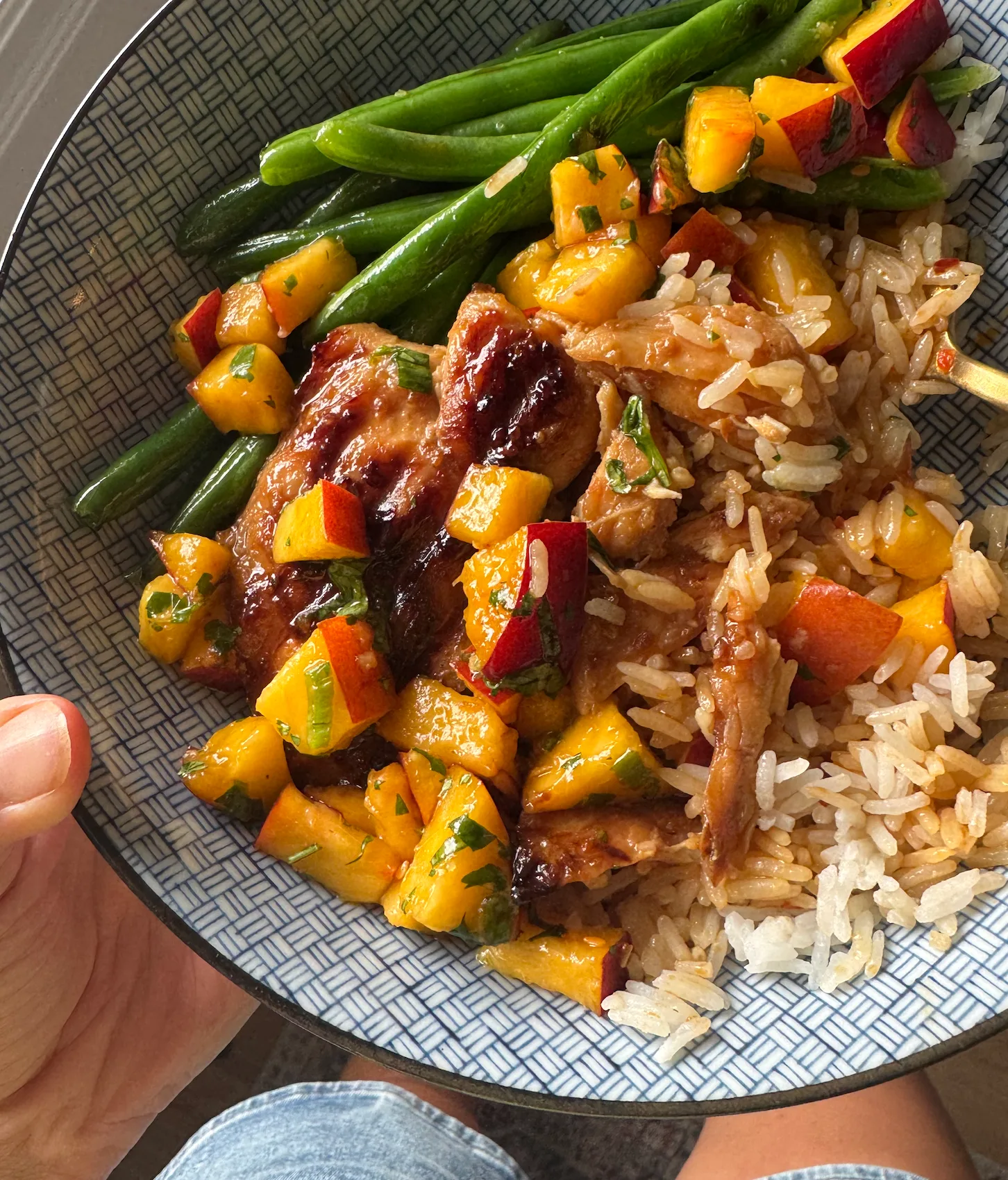 Teriyaki chicken in a bowl with rice, salsa, and green beans.