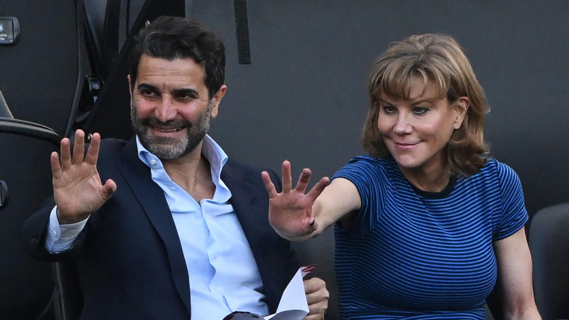 Former Newcastle United shareholders Mehrdad Ghodoussi (L) and Amanda Staveley wave from the directors' box