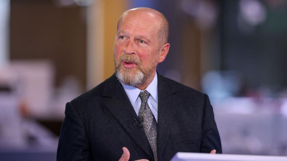 James Reed, chairman of Reed Executive Ltd., during a Bloomberg Television interview in London, UK in 2023. He is wearing a black suit jacket, a light coloured shirt with a grey and beige patterned tie.