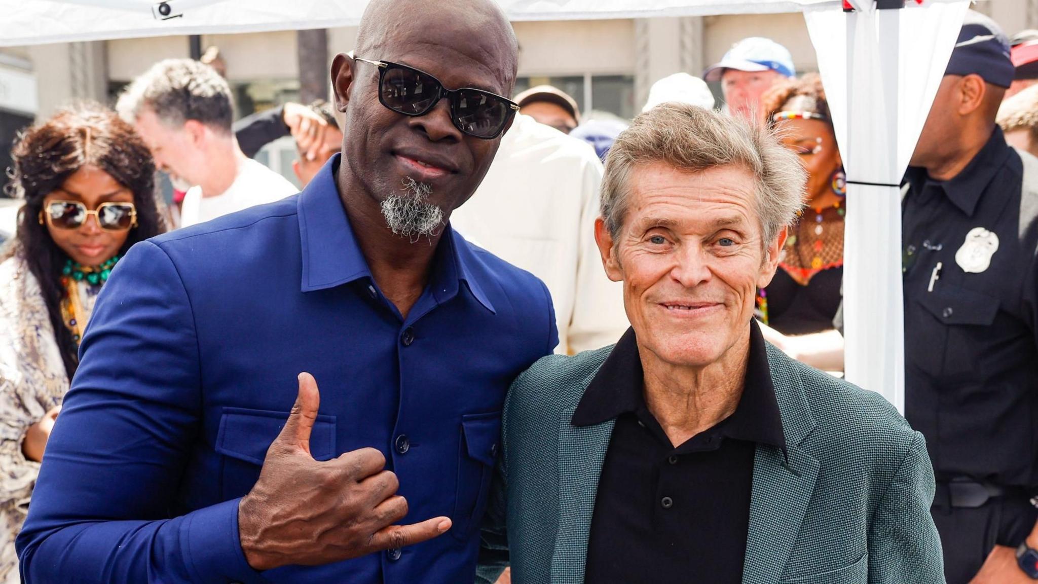 Djimon Hounsou (L) and US actor Willem Dafoe (R) attend the Hollywood Star ceremony for Beninese singer and five-time Grammy Award winner Angelique Kidjo