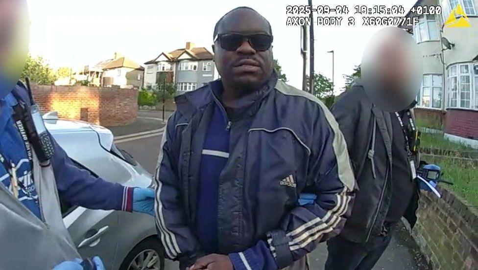 Still of Met Police detaining Simon Levy on a street