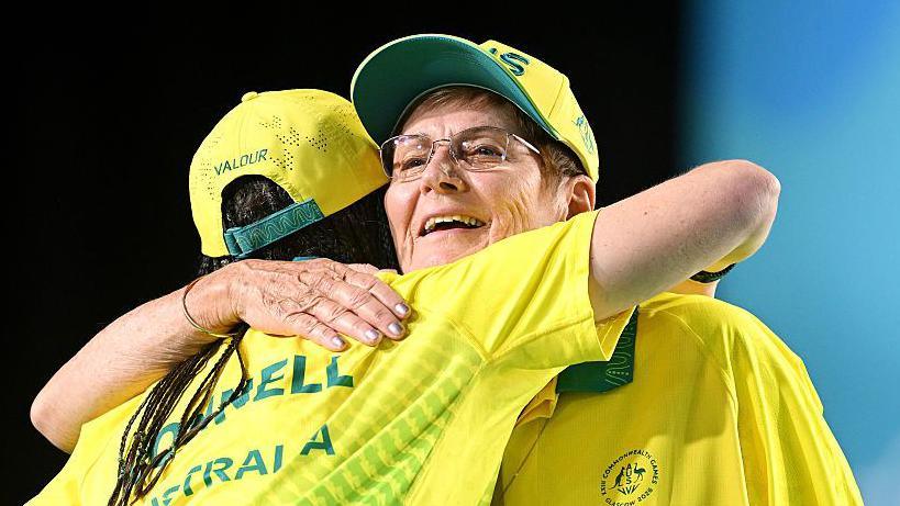 Louise Hoskins (right) hugs her Australian team-mate Serena Bonnell after winning gold