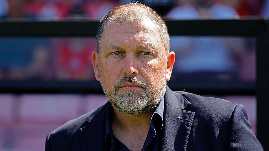 Peter Cklamovsk in a dark shirt and jacket during a game