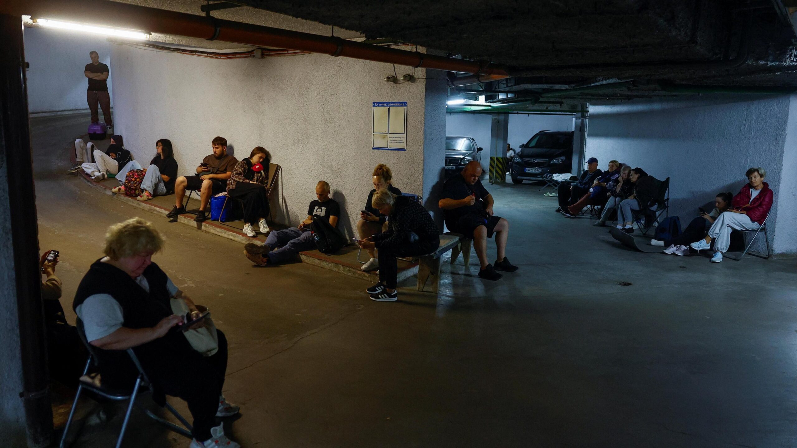 People take shelter inside an underground parking during Russian missile and drone strikes, amid Russia's attack on Ukraine, in Kyiv, Ukraine August 20, 2026