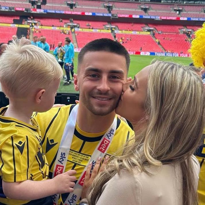 Jessica Beaumont pictured with her partner Owen Dale and their son Xavier when Oxford United secured promotion to the Championship