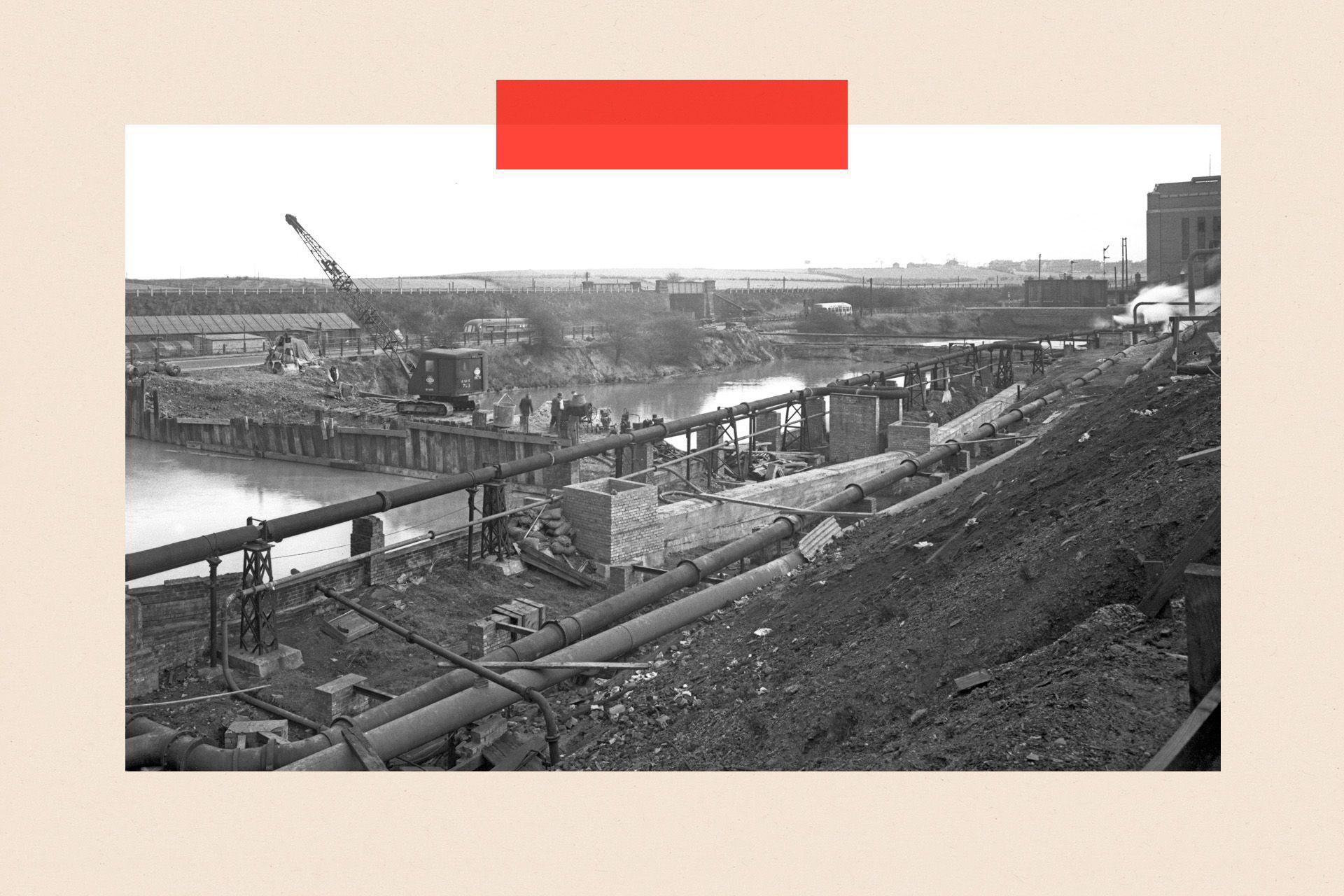 A black and white photo showing a reservoir being constructed