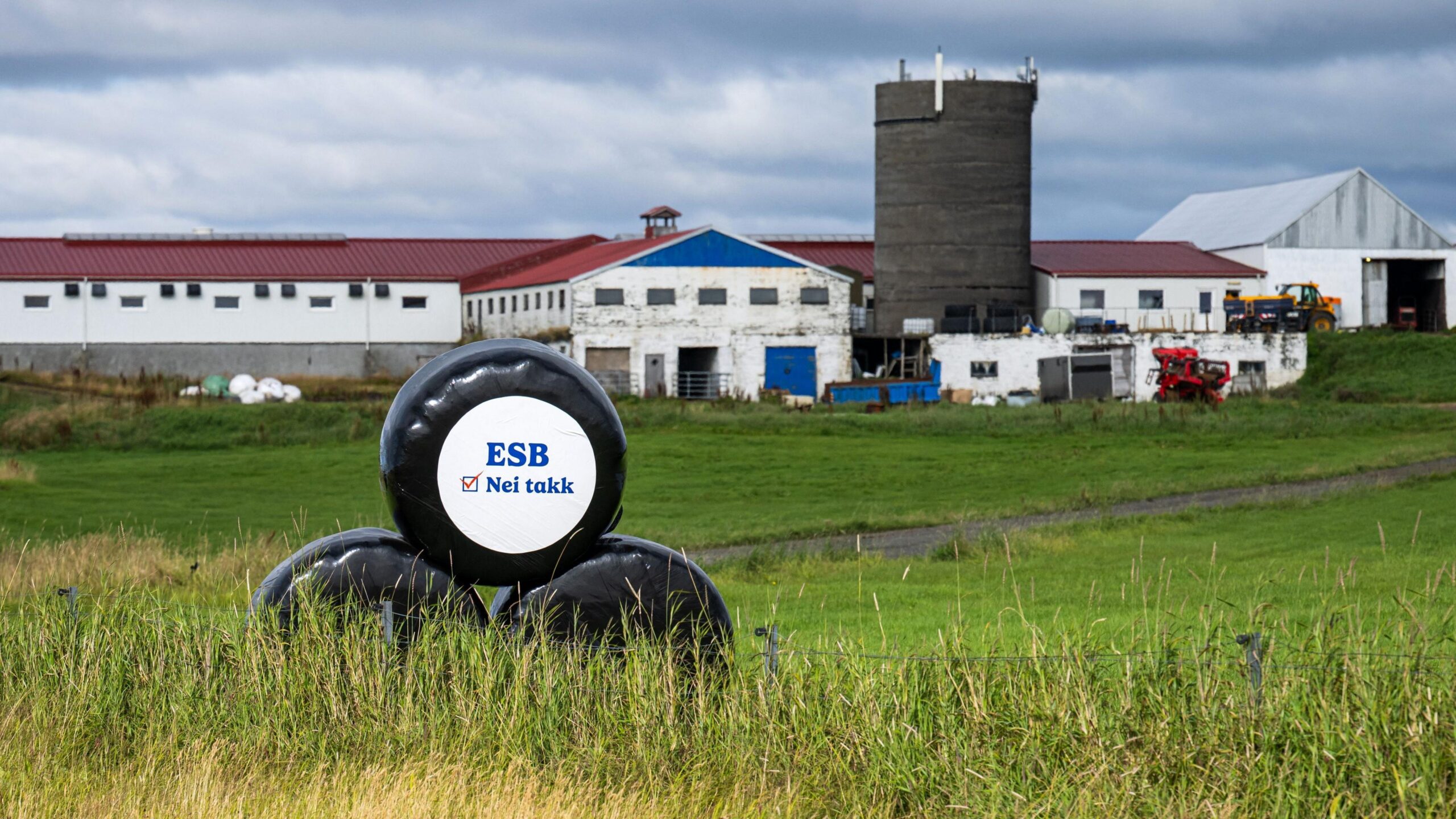 A "Nei takk" (No thanks) sign opposing the ESB (EU in Icelandic) is displayed on wrapped hay bales outside a farm near Reykjavík, Iceland.