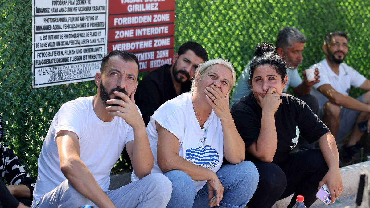 People wait for news of their relatives at Kyrenia port.