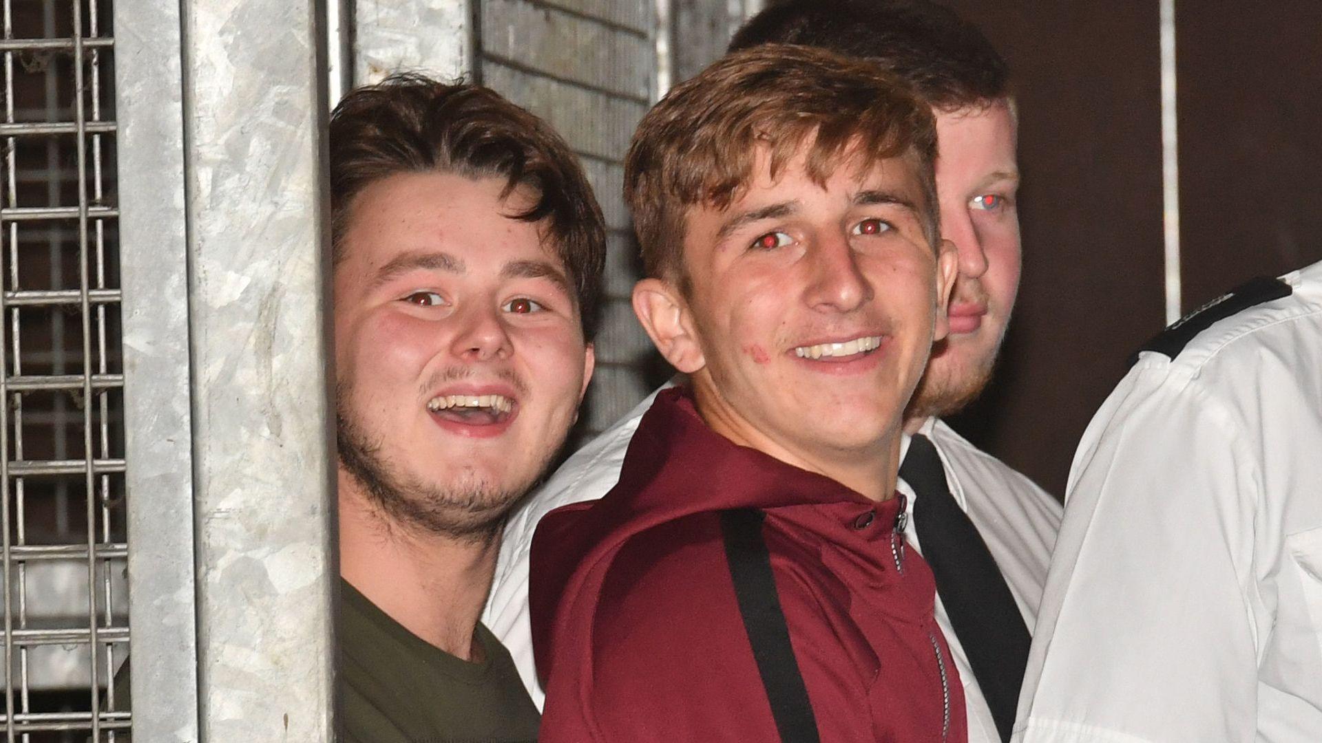 Albert Bowers (left) and Jessie Cole (centre), smiling, appearing to laugh or mock the assembled media, as they leave Reading Magistrates Court following an appearance in relation to the death of PC Andrew Harper.