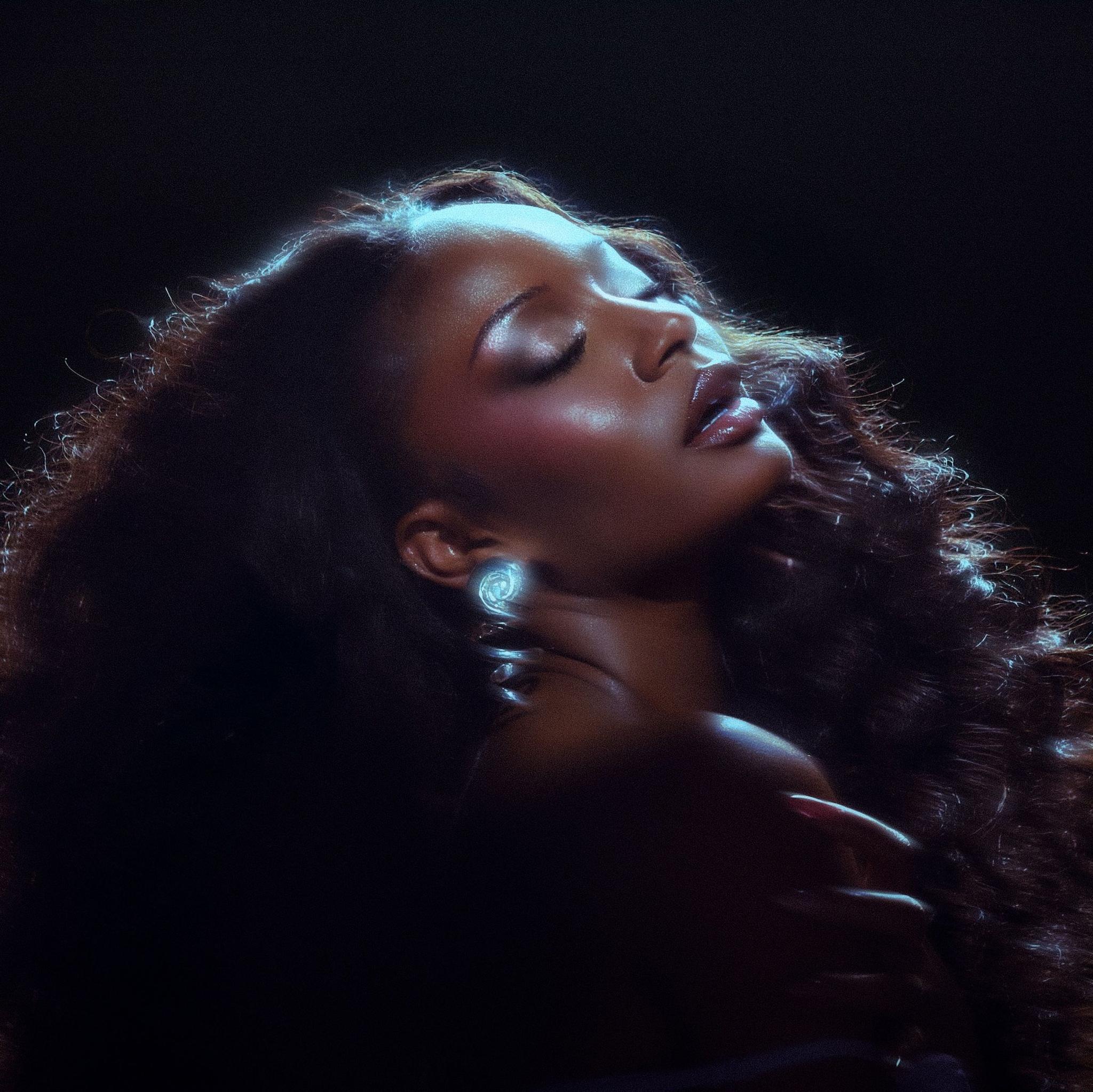 Promotional image of Ayra Starr shows the singer lit by a spotlight against a black background. She is tilting her head back with her eyes closed.