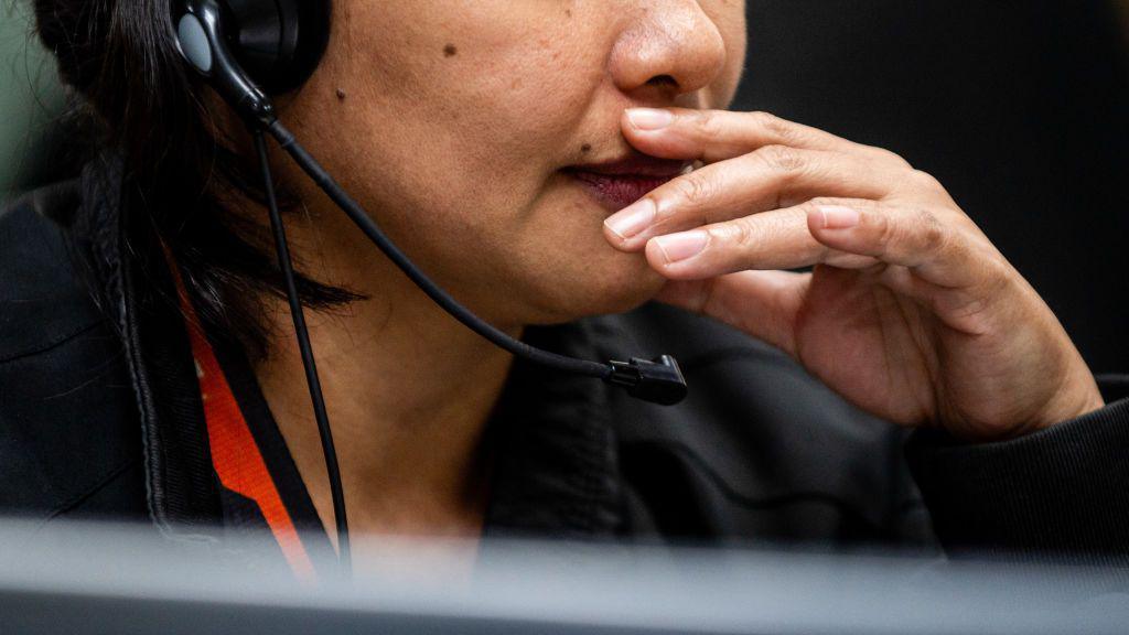 File picture of an employee speaking on the phone as she works in a Manila call centre.