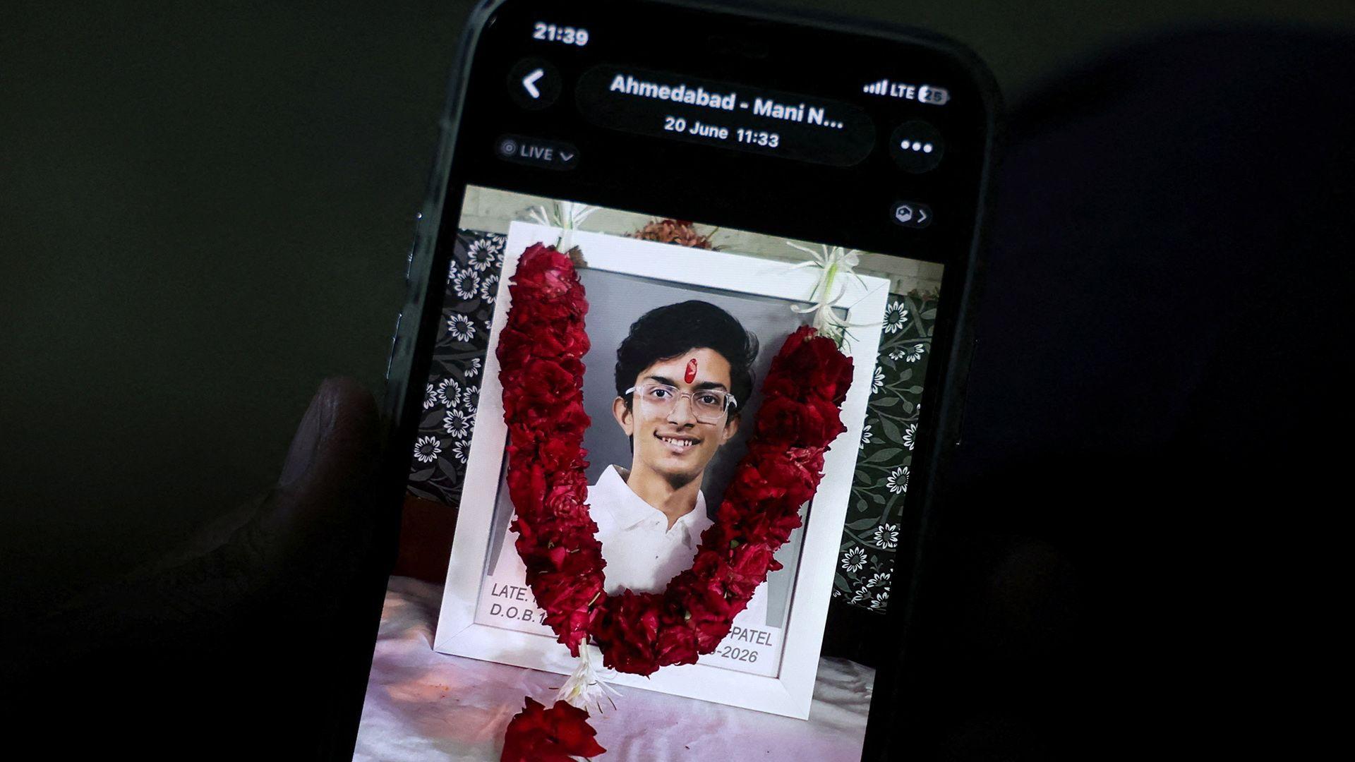 Prashant Patel, 45, shows a photo of his 17-year-old son Kahaan Patel, who took his own life ahead of the NEET exam retest, in Ahmedabad