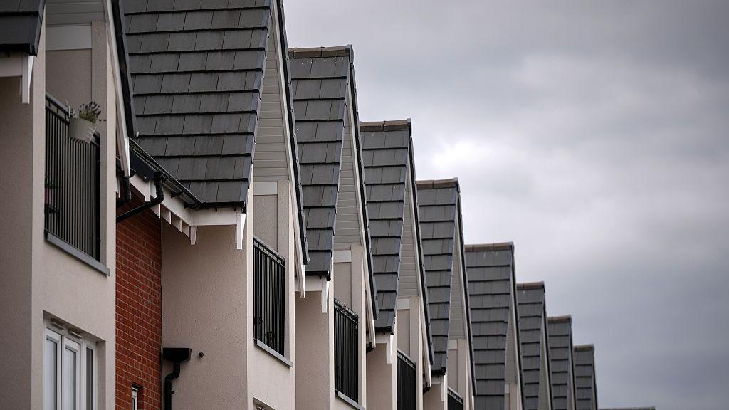The tops of new build houses standing in a  row
