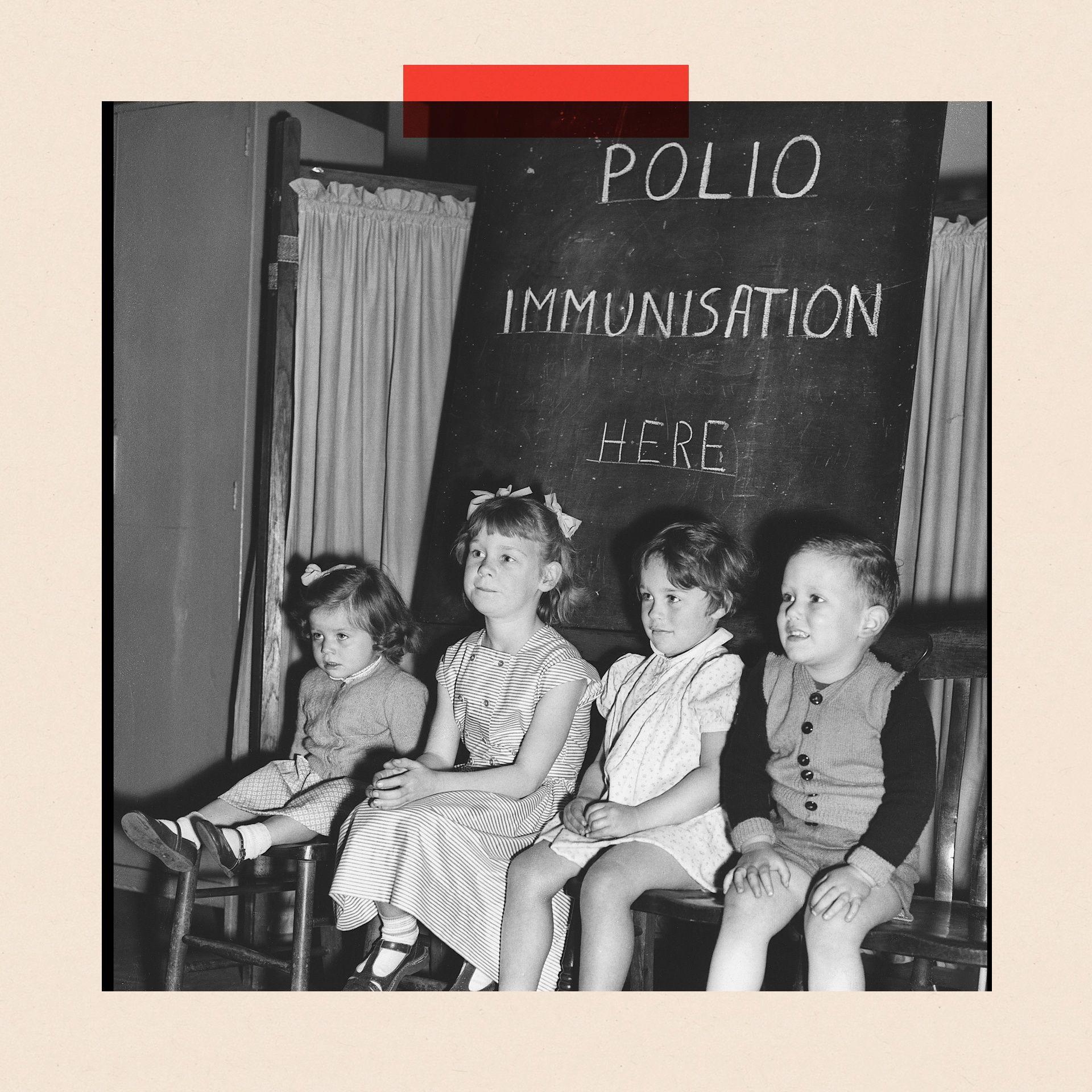 Four children sit beneath a blackboard reading 'Polio immunisations here'