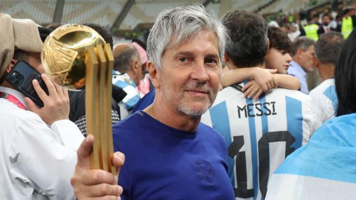 Jorge Messi holding his son Lionel Messi's trophy for best player at the 2022 World Cup after Argentina beat France in the final in Qatar