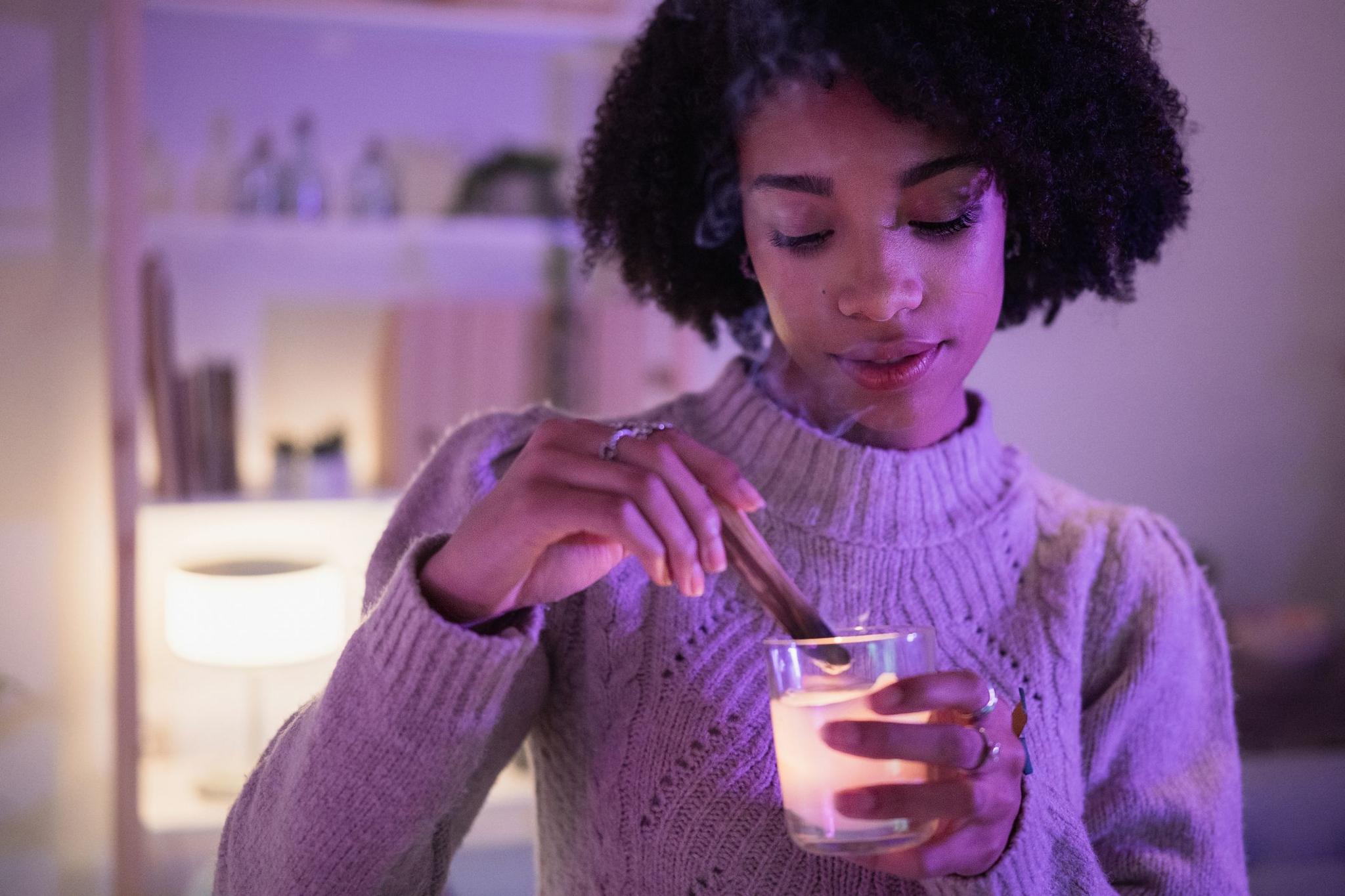 Young woman in jumped lights a candle