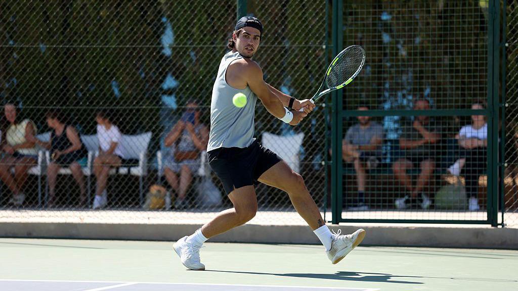 Carlos Alcaraz strikes a two-handed backhand during a tennis training session in Murcia, Spain
