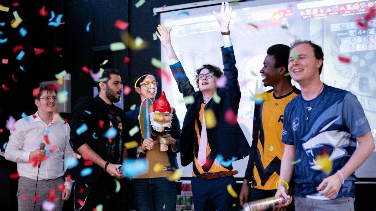 Six boys from the Roehampton esports team celebrating a win at a competition.