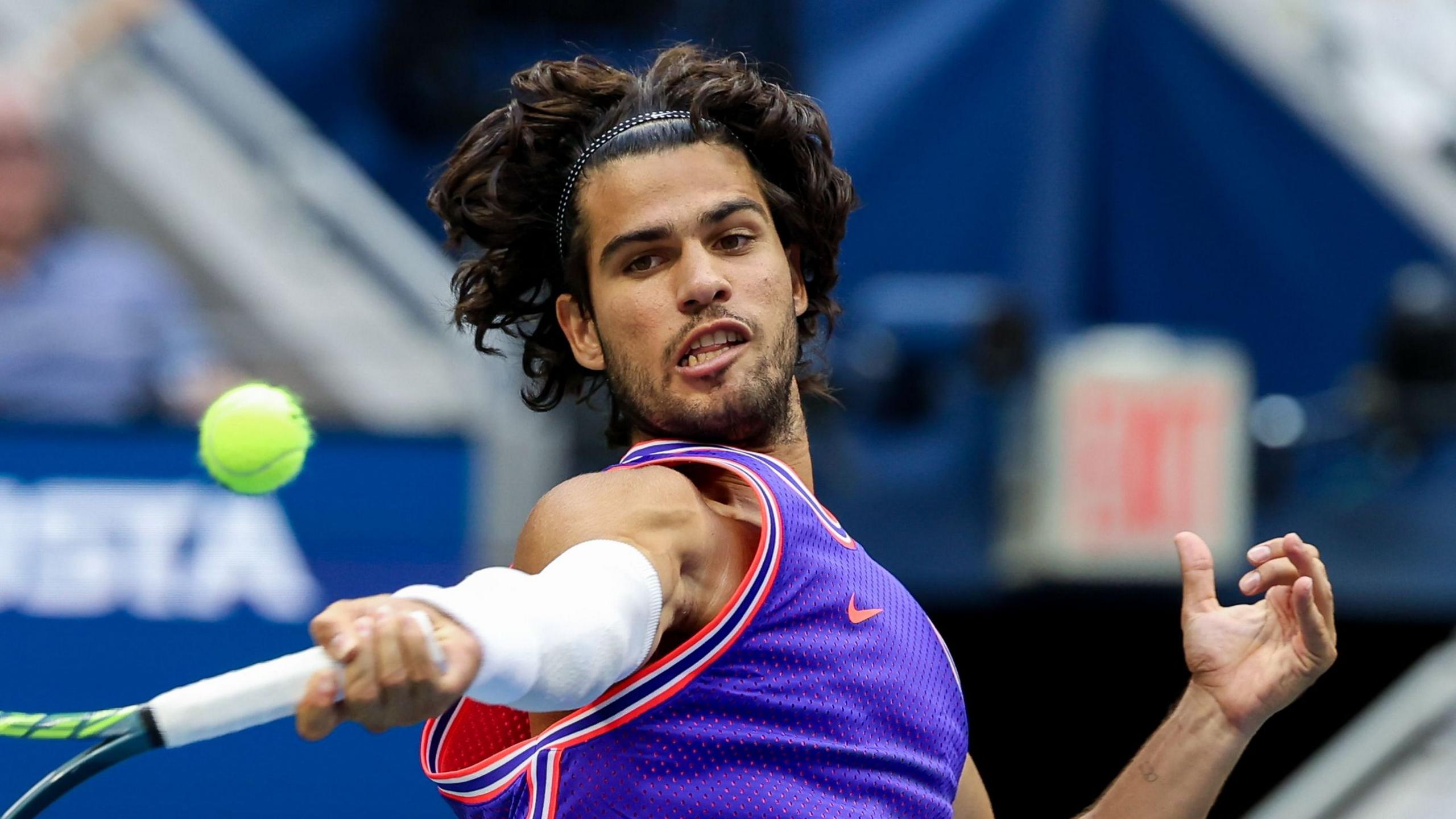 Carlos Alcaraz hits a return at the 2026 US Open
