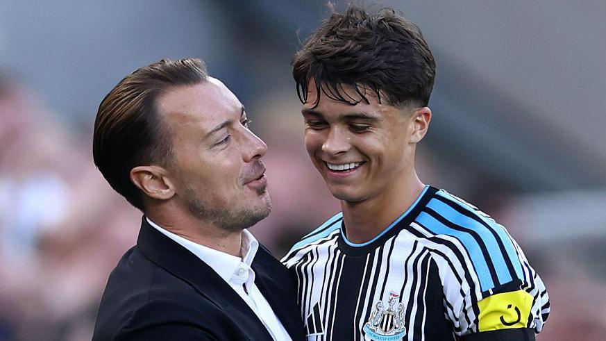 Newcastle boss Matthias Jaissle hugs Lewis Miley after the midfielder leaves the pitch