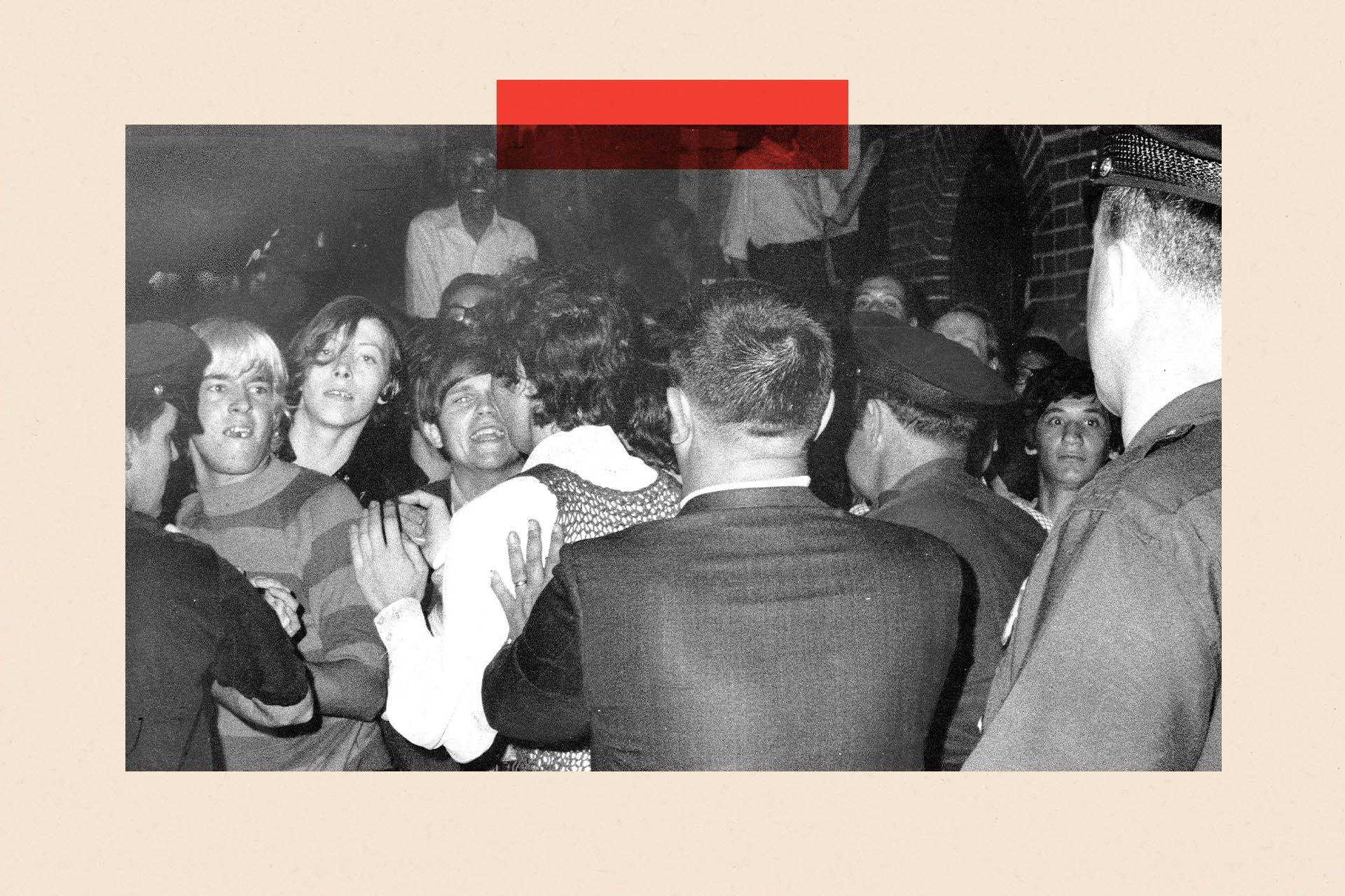 A black and white image of police raiding the Stonewall Inn