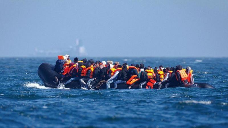 An inflatable small boat overloaded with people pictured in April 2026