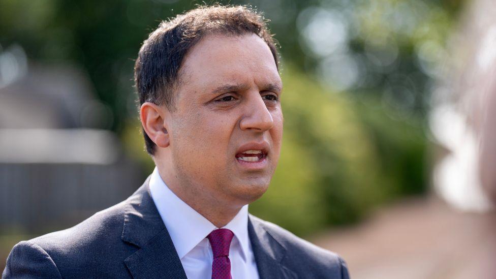 Anas Sarwar, who has short dark hair, in a business suit