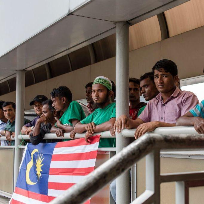 Rohingya men during a 2017 protest in Kuala Lumpur, with a Malaysian flag