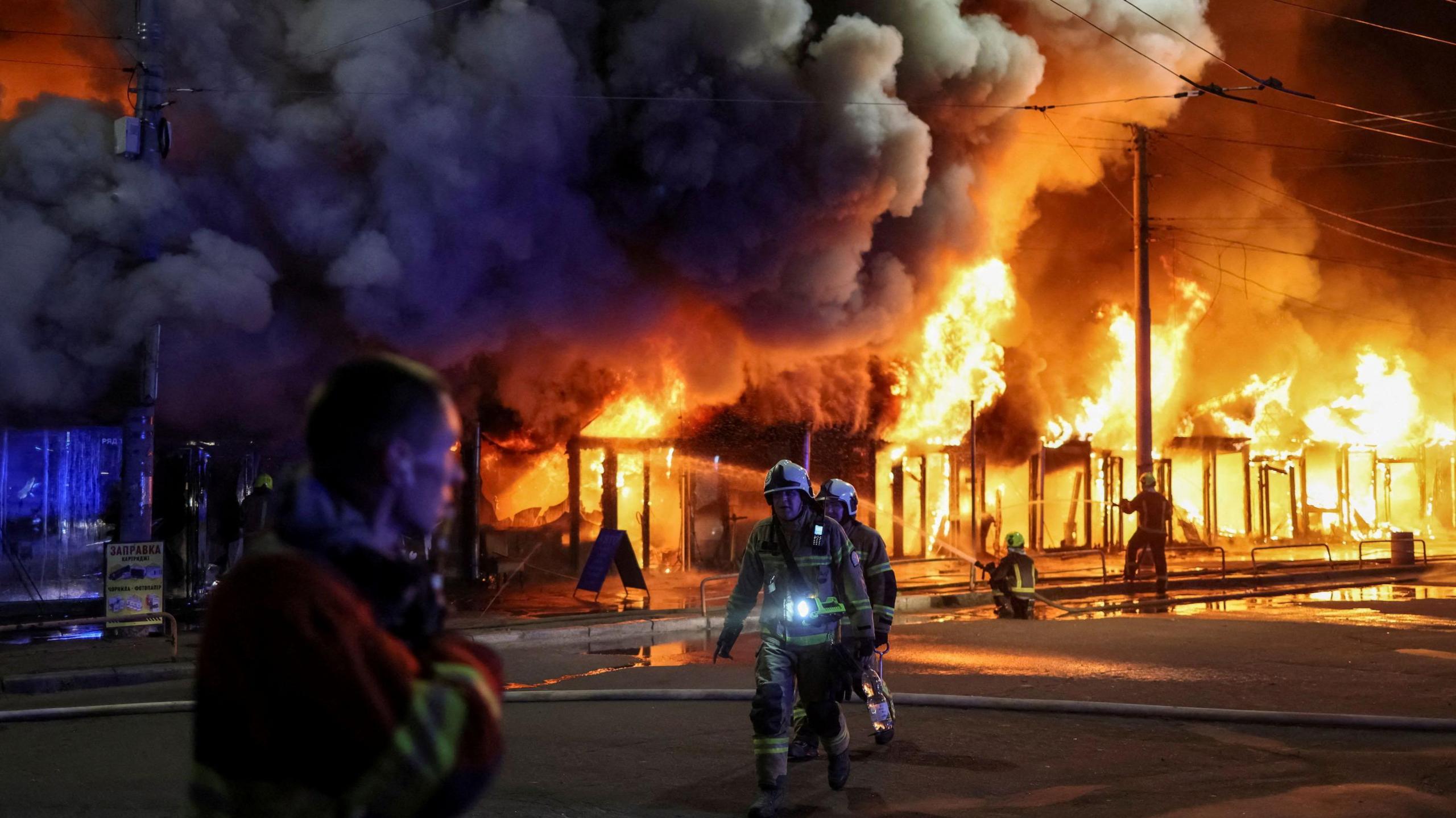 Firefighters work at a site of a book market hit by a Russian missile strike, amid Russia's attack on Ukraine, in Kyiv, Ukraine August 16, 2026.