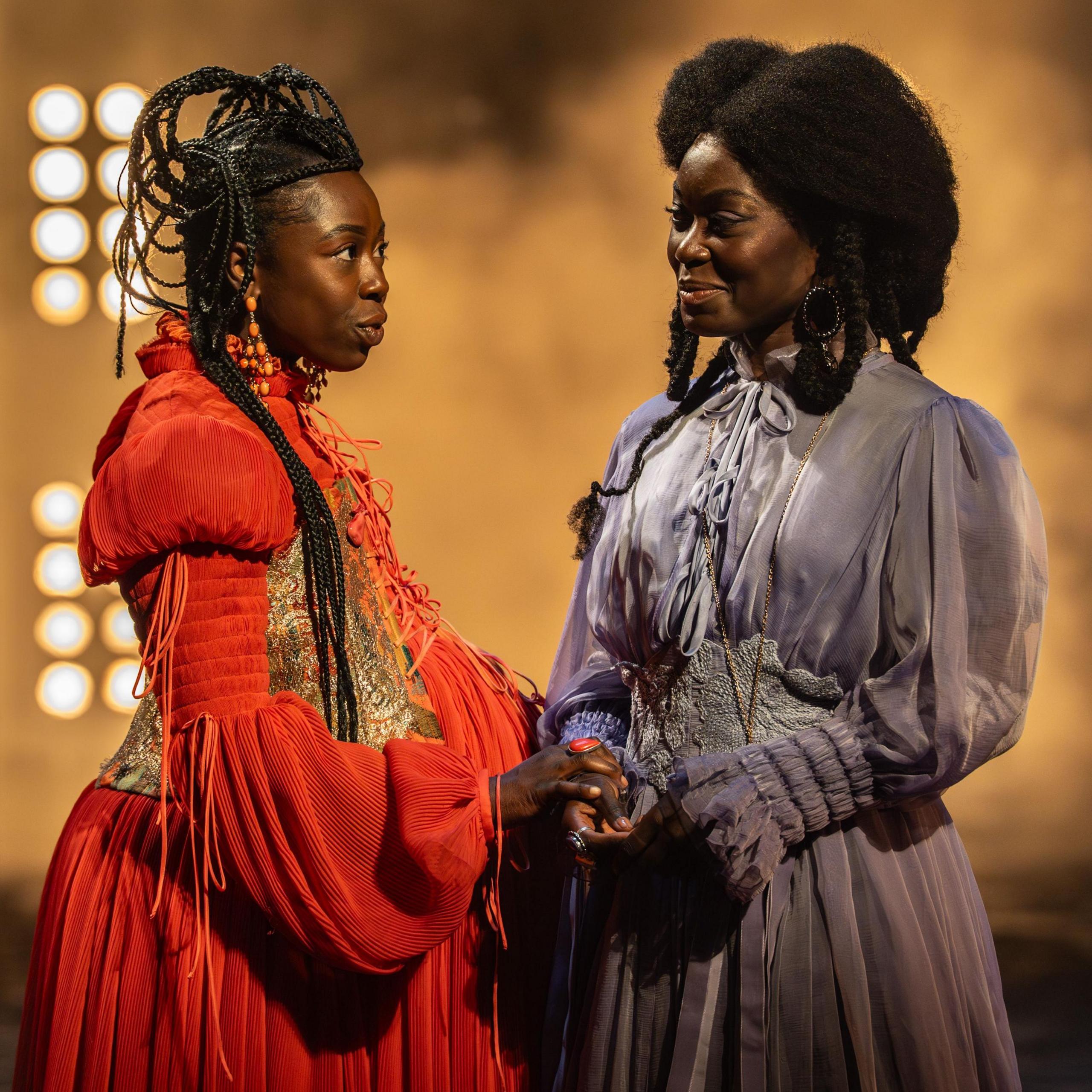Elizabeth Ayodele (Princess Elia Martell) and Tanisha Spring (Ashara Dayne) in costume standing and speaking in a scene from Game of Thrones: The Mad King
